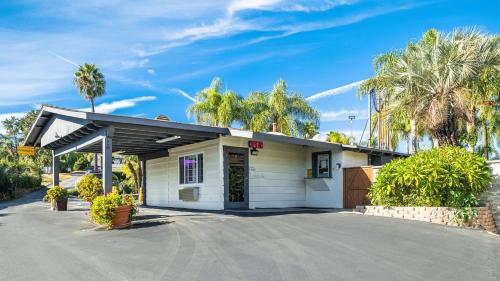 a small white building with a parking lot at Fallbrook Country Inn in Fallbrook