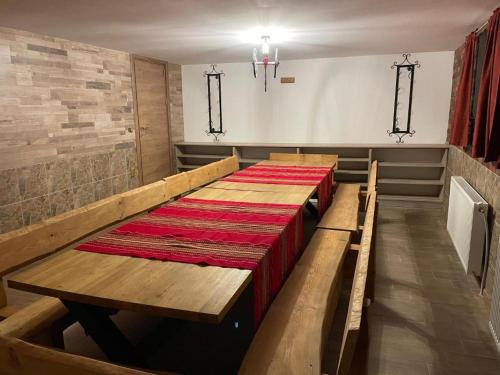 a row of pews in a church with a long table at Villa Euphoria in Bersin