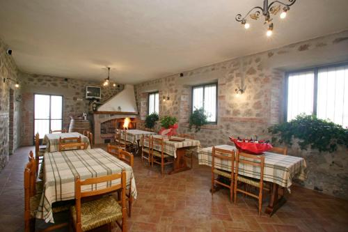 a restaurant with tables and chairs in a room at Agriturismo Parmoleto in Montenero