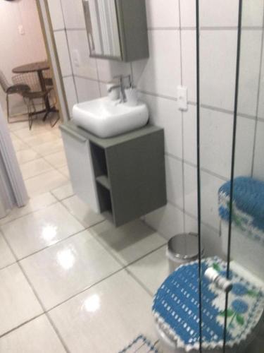ein Bad mit einem Waschbecken und einem Spiegel in der Unterkunft Flat Deluxe3 Gramado in Gramado