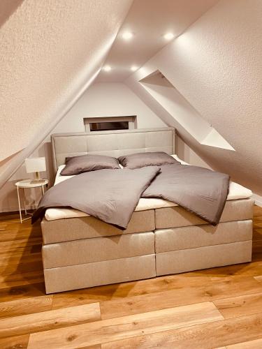 ein Schlafzimmer mit einem großen Bett im Dachgeschoss in der Unterkunft Home Again Studios in Rutesheim