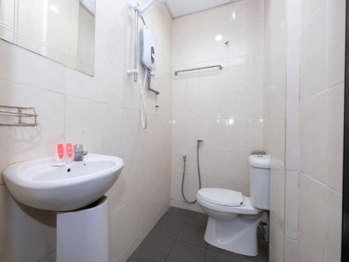 La salle de bains blanche est pourvue d'un lavabo et de toilettes. dans l'établissement Marjan Hotel Sdn Bhd, à Cukai