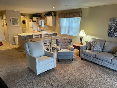 a living room with a couch and chairs and a kitchen at Escape To Branson in Branson
