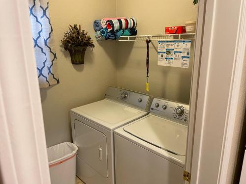 a washer and dryer in a small laundry room at Escape To Branson in Branson