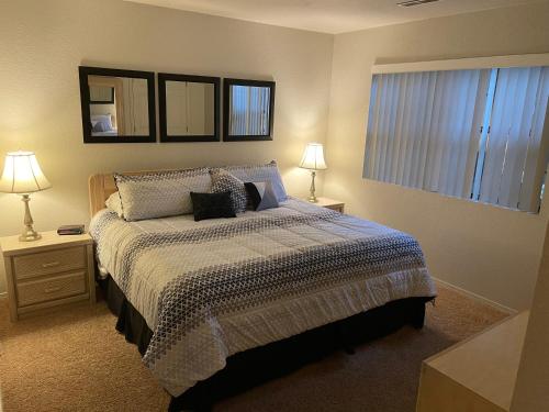 a bedroom with a bed with two night stands and two lamps at Escape To Branson in Branson