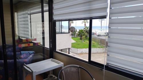 a room with a window with a view of the ocean at Canto del agua in La Serena