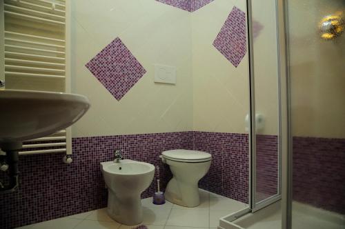 a bathroom with a toilet and a sink and a shower at Bed and Breakfast Villa Viviana in Anzio