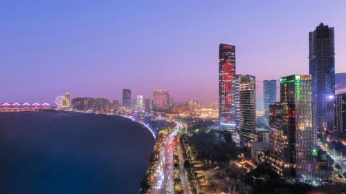 a view of a city at night with buildings at Holiday Inn Nanchang Riverside by IHG in Nanchang