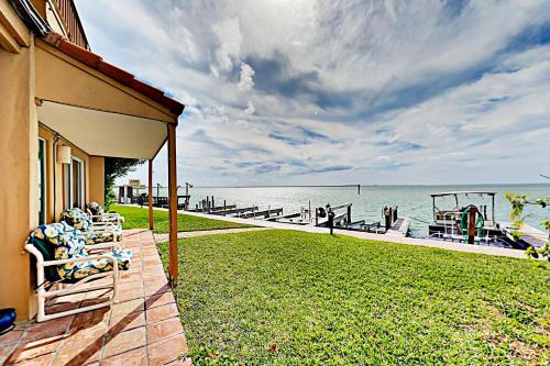a house with a deck with a view of the water at La Solana Condominiums #111 in South Padre Island