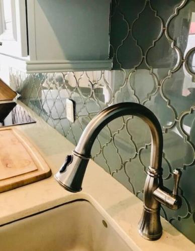 a kitchen sink with a faucet on a counter at Luxury Seafront 4p large ground floor apartment in Kralendijk
