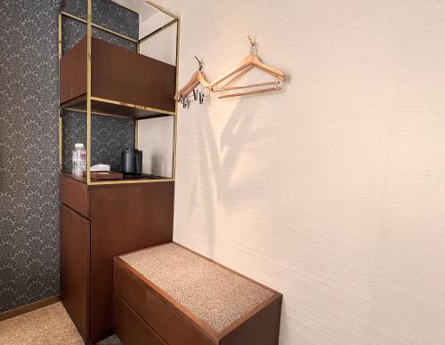 a walk in shower in a room with a wall at yoin hotel kyoto gion in Kyoto