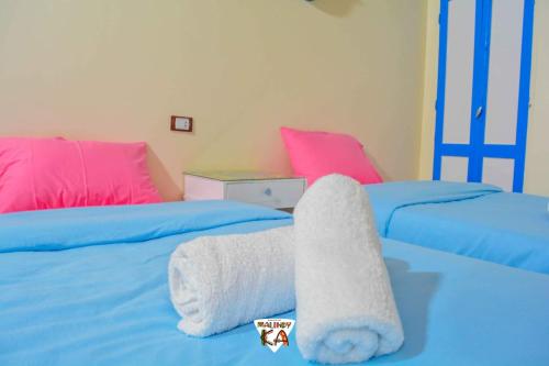 a bedroom with two beds with towels on them at malindy KA ماليندى كا in Aswan