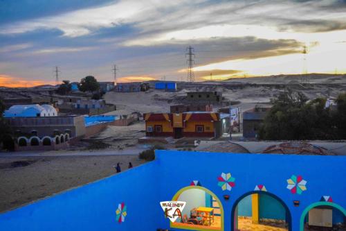 a view of a small town with a blue building at malindy KA ماليندى كا in Aswan