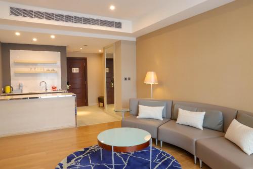 a living room with a couch and a table at Grand Victoria Hotel in Taipei