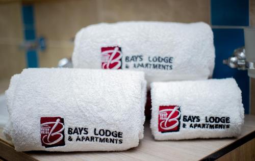 four stacks of white towels sitting on a counter at Bays Lodge, Accra in Accra