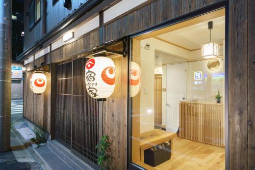 a store window with a sign on the side of a building at YADOYA 梟 in Tokyo