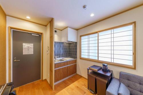 a living room with a couch and a window at YADOYA Fukurou in Tokyo