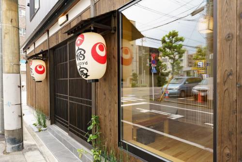 a window of a store with a sign on it at YADOYA Fukurou in Tokyo