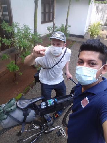 a man wearing a mask standing next to a bike at Villa DeLorenta in Anuradhapura