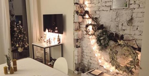 a room with a white brick wall with christmas lights at Veronika Home Tbilisi in Tbilisi City