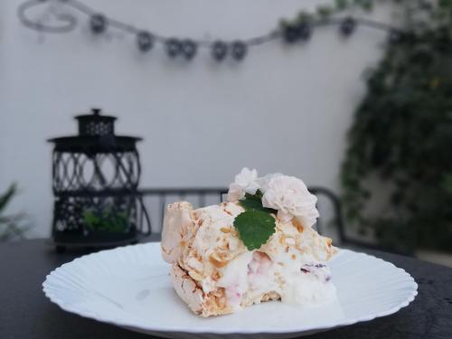 a piece of cake on a white plate on a table at Veronika Home Tbilisi in Tbilisi City