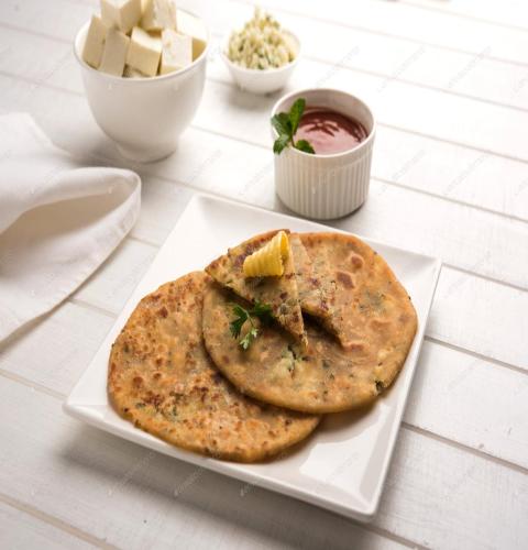 a white plate with two naan bread on a table at FabHotel Amaltas in Rānchī