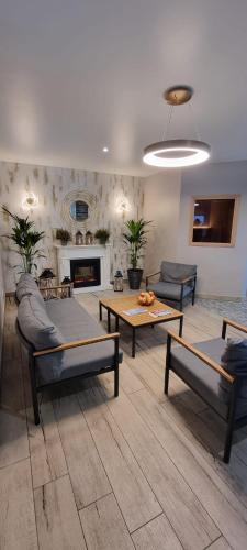 a living room with two couches and a fireplace at Irbēni in Brivkalni