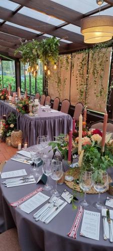 a long table with wine glasses on it at Irbēni in Brivkalni