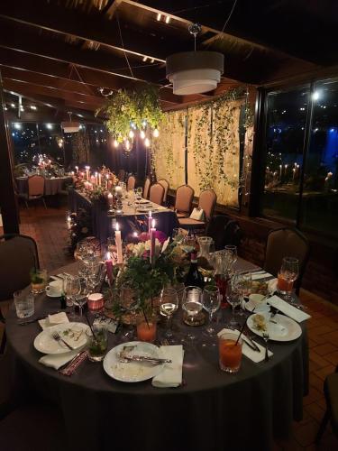 a long table with plates and wine glasses on it at Irbēni in Brivkalni