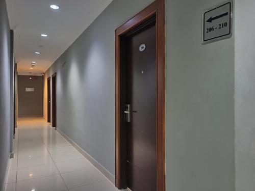 a hallway with a door in a building at Anggerik Garden Hotel - AG Hotel in Sitiawan