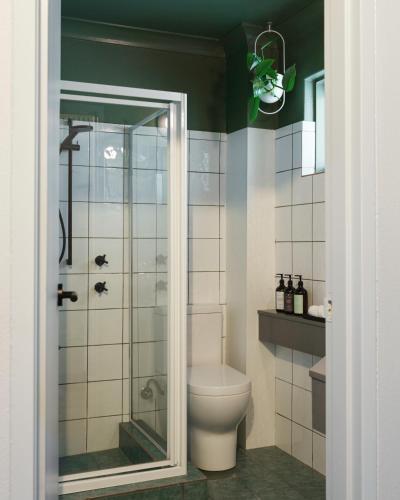 a bathroom with a toilet and a glass shower at Kyah in Blackheath