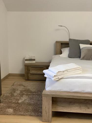 a bedroom with a bed with white sheets and a lamp at La Mimi Villa in Sadu