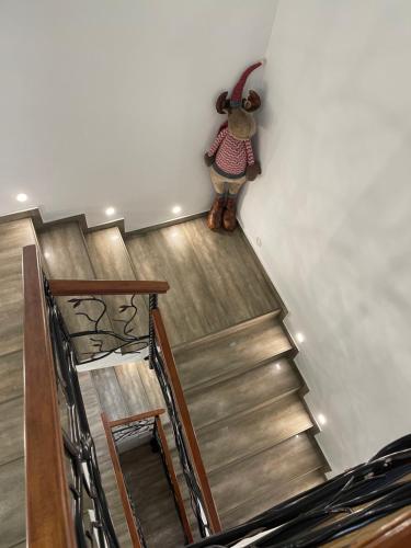 a stuffed animal standing on the side of a stairs at La Mimi Villa in Sadu