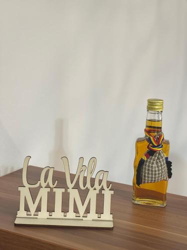 a bottle of whisky sitting on a table with a sign at La Mimi Villa in Sadu