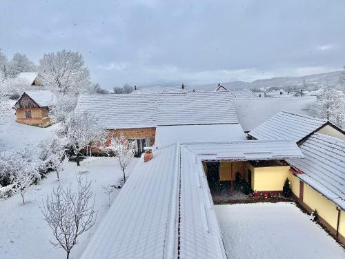 a snow covered roof of a house covered in snow at La Mimi Villa in Sadu