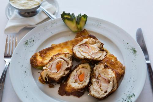 a plate of food with meat and broccoli on it at Hotel Damis in Pale