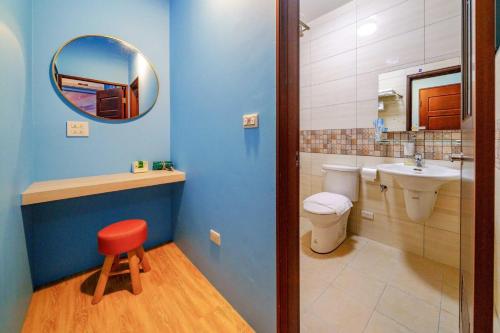 a bathroom with a toilet and a sink and a mirror at Han Tian Tongyu in Wujie