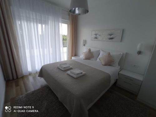 a bedroom with a bed with two towels on it at FAMILY VILLA WITH POOL-Peaceful Hvar Island Oasis in Bogomolje