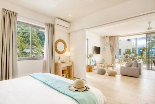 a bedroom with a bed with a hat on it at Pineapple Beach Villas in Baie Lazare Mahé