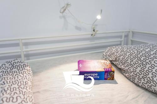 a bedroom with a bed and a pile of books at Downtown River Hostel in Donostia-San Sebastián