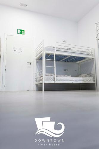 a white bunk bed in a white room at Downtown River Hostel in Donostia-San Sebastián