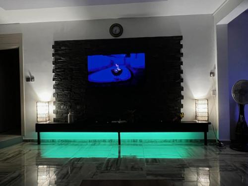 a living room with a tv and a fireplace at Villa Annjo in Pointe aux Piments