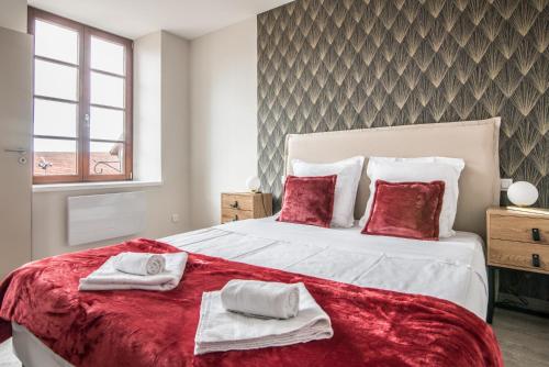 a bedroom with a large bed with two towels on it at Centre - Le Contemporain - Parking in Drulingen