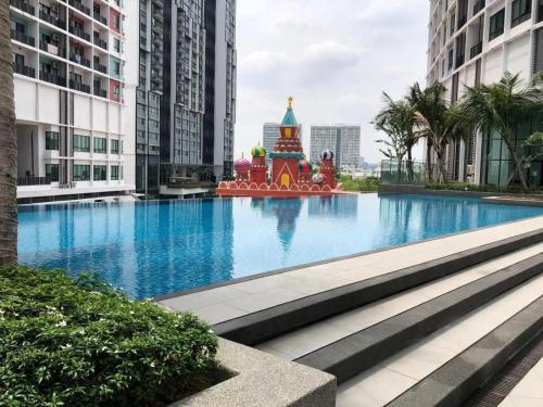 a large swimming pool in a city with tall buildings at i-Suite, i-City by Mohas Homes in Shah Alam