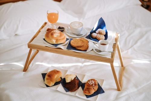 a tray of biscuits and pastries on a bed at Santa Rosa Relais in Noci