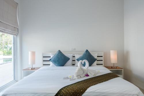 Ένα ή περισσότερα κρεβάτια σε δωμάτιο στο The Beach Village Resort
