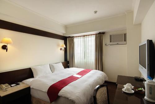 מיטה או מיטות בחדר ב-Liga Hotel
