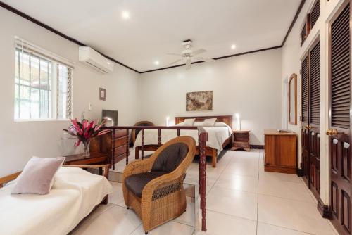 a living room with two beds and a balcony at Posada el Quijote in San José