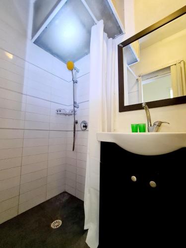 a bathroom with a sink and a mirror at Nice apartments on Ben Yehuda str in Tel Aviv