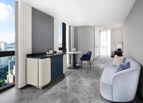 a living room with a desk and chairs in a building at Sofitel Ambassador Seoul Hotel & Serviced Residences in Seoul